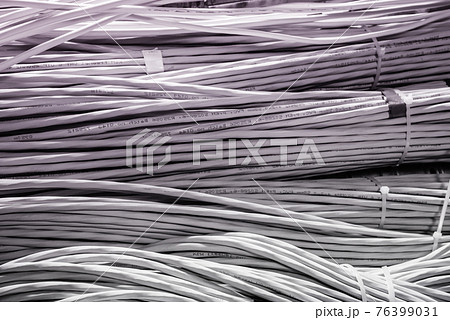 bunch of network cables in wave pattern leading across server ro 76399031