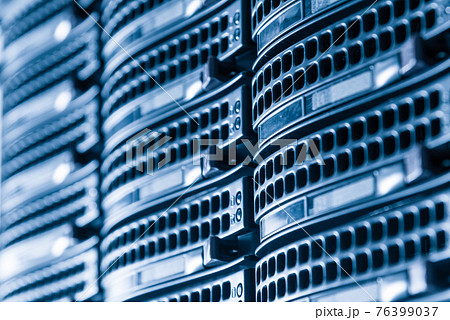 Cluster of data storage hard drives inside server room 76399037