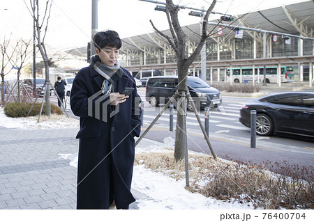 Asian man with smartphone 76400704