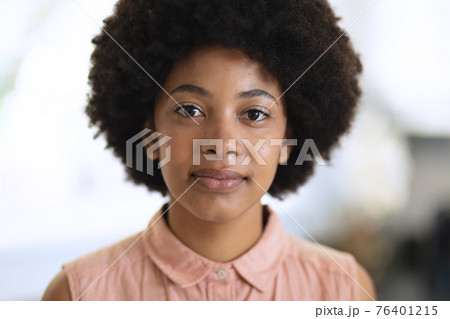 Portrait of african american woman looking at camera and smiling Portrait of african american woman looking at camera and smiling 76401215