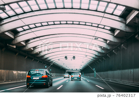 Speeding Cars Traffic Inside A Highway Urban Tunnel. Trip Travel Concept On Vehicle. Urban City Road. Copy Space. Speeding Cars Traffic Inside A Highway Urban Tunnel. Trip Travel Concept On Vehicle. Urban City Road. Copy Space. 76402317