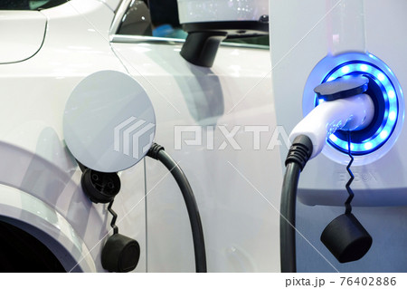 Close-up modern white  EV Car rechargeable energy form electric charge machine, Electric power is an alternative fuel for smart vehicles 76402886