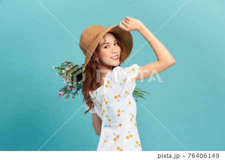 Cute young woman in summer short dress with purple flowers in her hands Cute young woman in summer short dress with purple flowers in her hands 76406149
