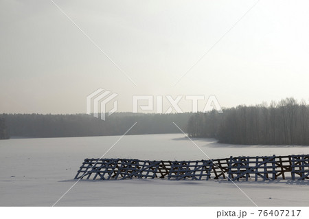 deep snow drifts and trees after the last snowfall 76407217