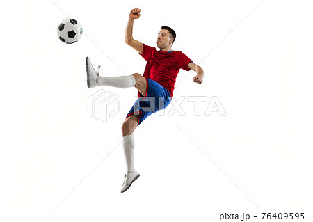 Young Caucasian soccer football player training isolated on white background. Young Caucasian soccer football player training isolated on white background. 76409595