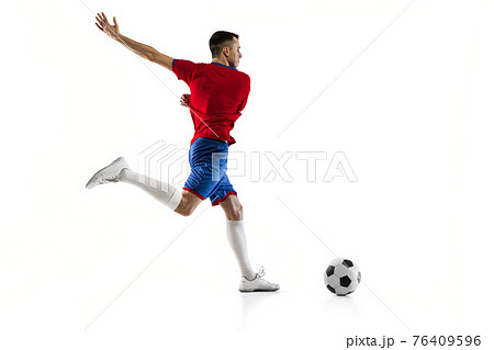 Young Caucasian soccer football player training isolated on white background. 76409596