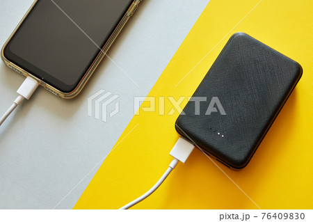 Power bank charges smartphone using a USB cable Power bank charges smartphone using a USB cable 76409830