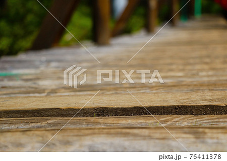 Selective focus. View of the wooden path. 76411378