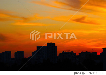 Beautiful bright sunset on a summer day over the city. Beautiful bright sunset on a summer day over the city. 76411399