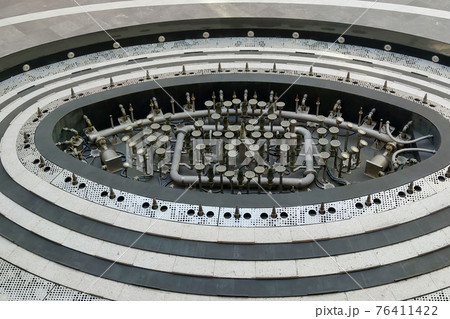 View of the idle fountain on the street. View of the idle fountain on the street. 76411422