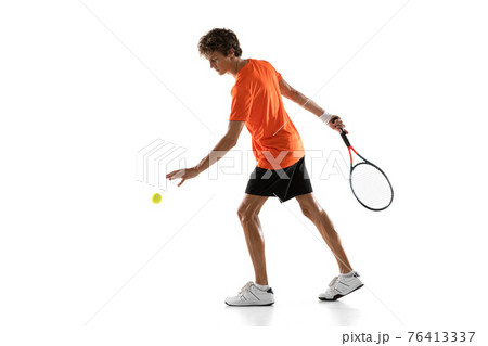 Young Caucasian man, tennis player posing isolated on white background. Young Caucasian man, tennis player posing isolated on white background. 76413337