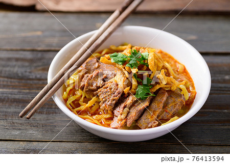 Northern Thai food (Khao Soi), Spicy curry noodles soup with beef 76413594