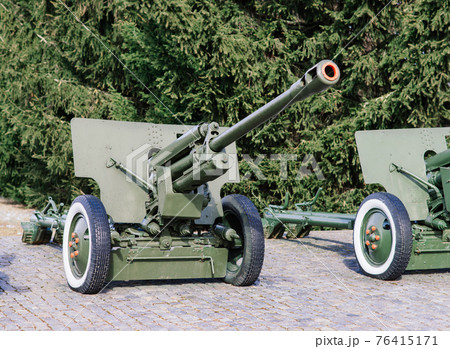 View of the russian cannons and howitzers in a park. Military museum outdoors View of the russian cannons and howitzers in a park. Military museum outdoors 76415171
