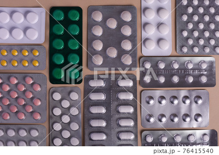 Pill tablets in a blister pack. Lots of flu medications.  76415540