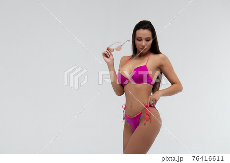 Slim woman in swimwear with sunglasses 76416611