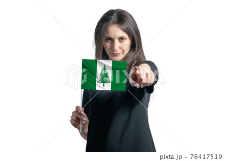 Happy young white woman holding flag of Norfolk Island and points forward in front of him isolated on a white background Happy young white woman holding flag of Norfolk Island and points forward in front of him isolated on a white background 76417519
