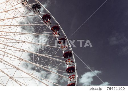 Ferris wheel in an amusement park.Blue sky. Copy space Ferris wheel in an amusement park.Blue sky. Copy space 76421100