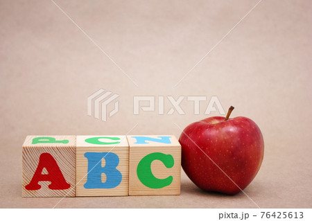 English ABC alphabet letters next to the red apple . English ABC alphabet letters next to the red apple . 76425613