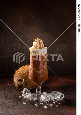 Delicious cold refreshing ice coffee in cocktail glass with coconut 76426226