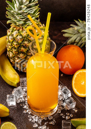 Delicious cold refreshing orange smoothie drink in cocktail glass with ananas, kiwi and banana Delicious cold refreshing orange smoothie drink in cocktail glass with ananas, kiwi and banana 76426248