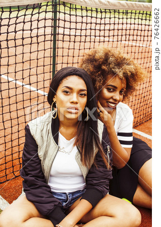 young pretty girlfriends hanging on tennis court, fashion stylish dressed swag, best friends happy smiling together young pretty girlfriends hanging on tennis court, fashion stylish dressed swag, best friends happy smiling together 76426662