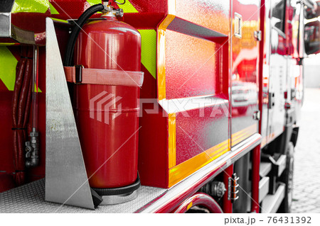 Fire fighter truck equipped with the latest orange fire extinguishing hoses 76431392