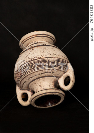 Clay amphora is overd by a black background Clay amphora is overd by a black background 76431882