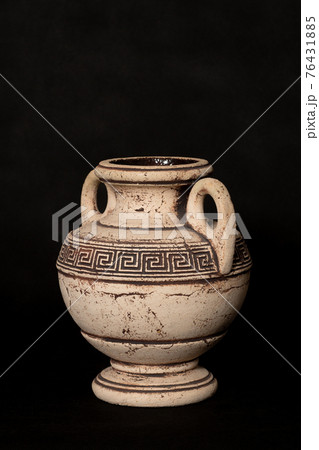 Amphora stands in a turn on a black background Amphora stands in a turn on a black background 76431885