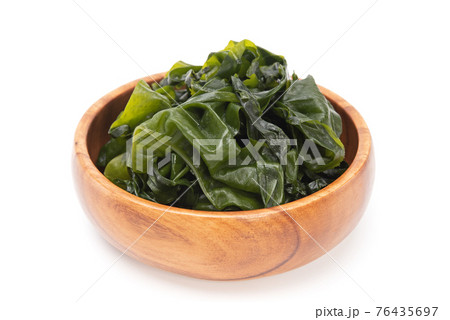 Fresh seaweed wakame in wooden bowl isolated on white background. Japanese food 76435697