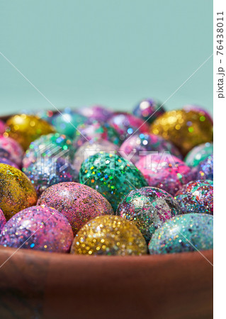 Many colorful shiny eggs. Concept of Happy Easter. Many colorful shiny eggs. Concept of Happy Easter. 76438011