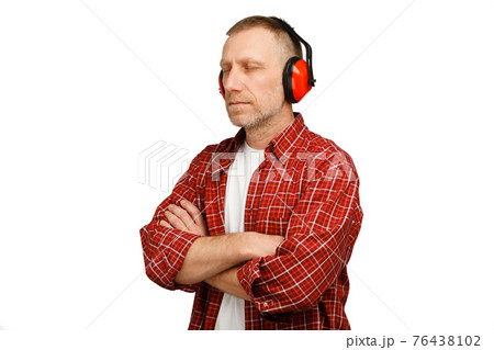 A person wearing hearing protection. Studio shot isolated on white background A person wearing hearing protection. Studio shot isolated on white background 76438102