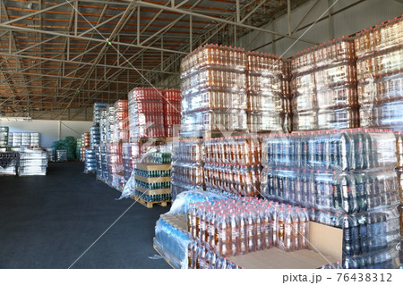 Many packaged mineral water bottles in stock in a store Many packaged mineral water bottles in stock in a store 76438312