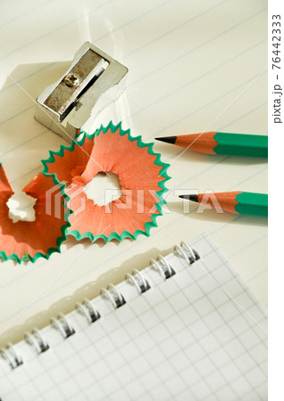 Green wooden pencils and notepad opened with pencil sharpener Green wooden pencils and notepad opened with pencil sharpener 76442333