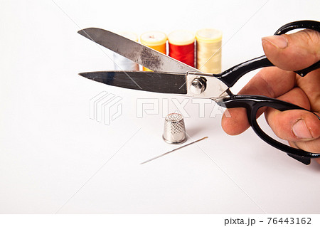 Sewing supplies, hand tailor scissors colorful threads needle and thimble, isolated on white background 76443162