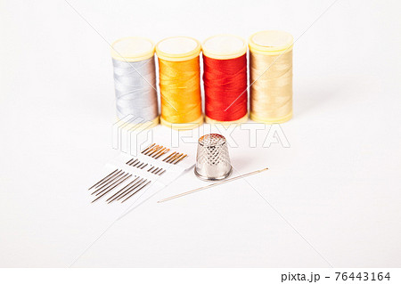 Sewing supplies, colorful threads needle and thimble, isolated on white background 76443164