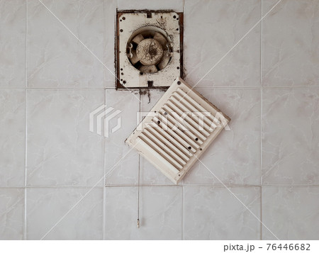 Dirty ventilation air grille with fan at home close up on white wall. Dust condition technology, dangerous old house air circulation system. Bad filtration indoors. Horizontal concept 76446682
