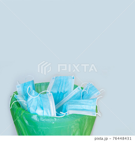 Used mask thrown in trash bin, discarded disposable surgical masks Used mask thrown in trash bin, discarded disposable surgical masks 76448431