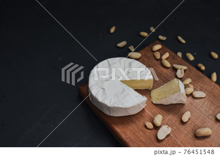 cheese camembert with mold and nuts on wooden board cheese camembert with mold and nuts on wooden board 76451548