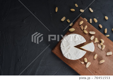 cheese camembert with mold and nuts on wooden board 76451553