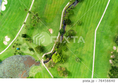 Aerial view drone shot of beautiful green golf field fairway and putting green Top down image for sport background and travel nature background Amazing view 76456640
