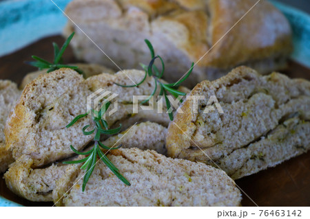 Beautiful freshly baked homemade bread with a sprig of rosemary. Beautiful freshly baked homemade bread with a sprig of rosemary. 76463142