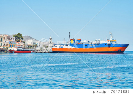 Moored large ferry on sea against old town 76471885