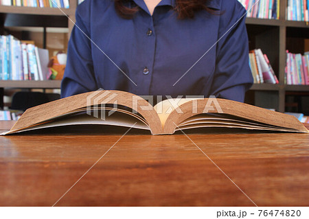 Asian women in library, reading, studying. Asian women in library, reading, studying. 76474820