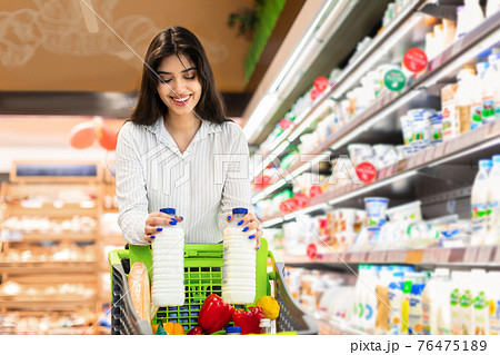 Cheerful Arabic Woman Doing Grocery Shopping Buying Milk In Supermarket 76475189