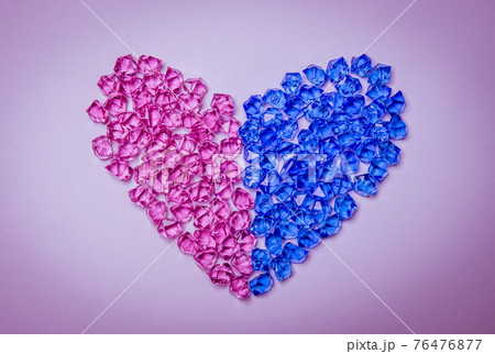 Heart shape made of pink and blue crystals or gemstones on bright background. Heterosexual relationship concept Heart shape made of pink and blue crystals or gemstones on bright background. Heterosexual relationship concept 76476877