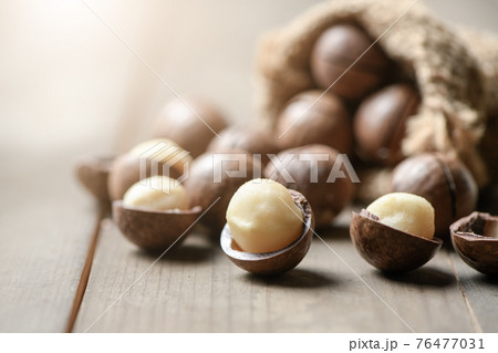 Peeled macadamia nuts on wood background, Macadamia nuts are loaded with flavonoids and tocotrienols and rich in heart-healthy monounsaturated fats Peeled macadamia nuts on wood background, Macadamia nuts are loaded with flavonoids and tocotrienols and rich in heart-healthy monounsaturated fats 76477031