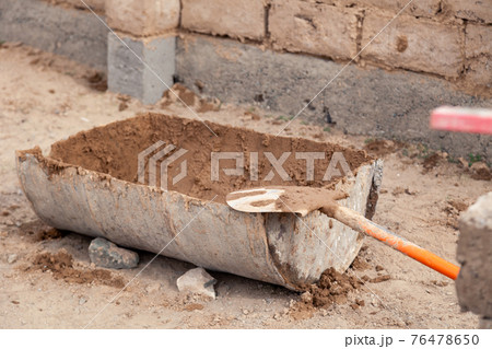 Half of metal barrel with cement, dirty old shovel in concrete Half of metal barrel with cement, dirty old shovel in concrete 76478650