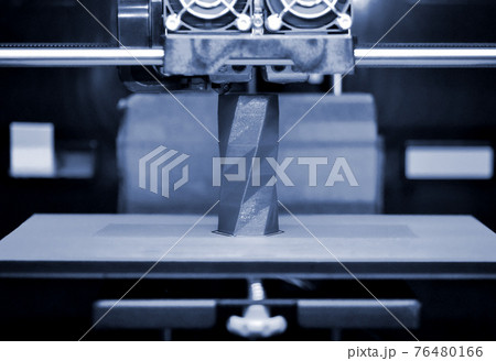 3D printer works and creates an object from the hot molten plastic 76480166