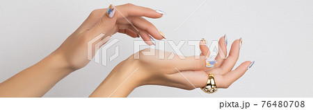 Young adult womans hands with fashionable nails on white background. Manicure, pedicure beauty salon concept. 76480708