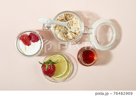 Homemade strawberry face mask ingredients: strawberry, yoghurt, honey, lemon, oatmeal. 76482909